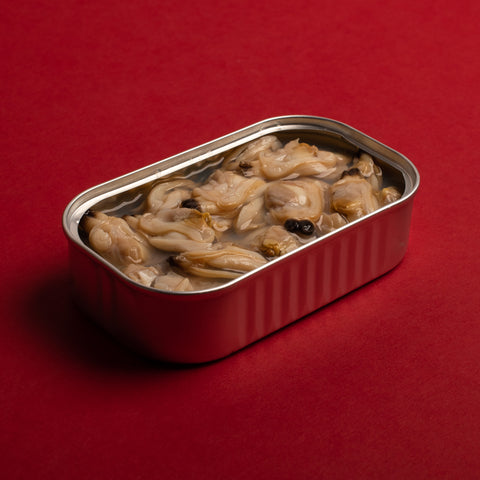 Opened tinned clams, rich in flavour. with a powerful red background supporting the claims.