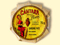 A round tin of sardine pâté in a glossy paper wrap with an illustration of a woman in a red dress beneath Cântara written in red lettering