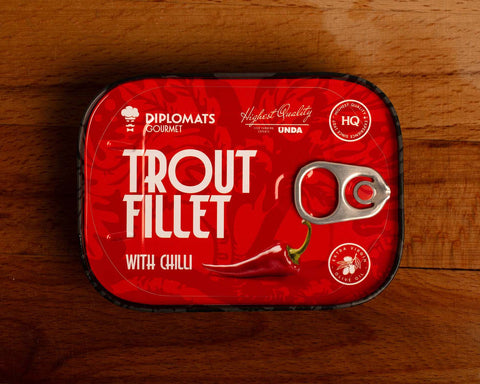 Trout fillet with chilli in extra virgin olive oil, packaged in a red tin with black borders with an illustration of a chilli pepper.