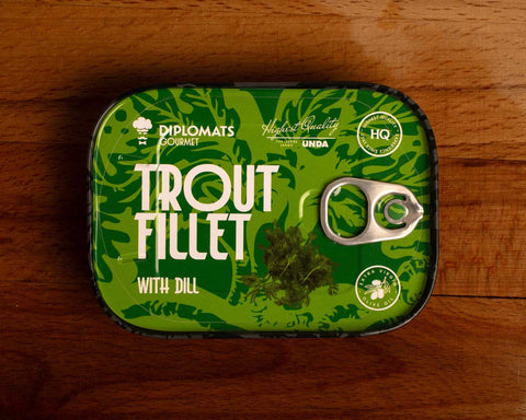 Trout fillet with dill in extra virgin olive oil, packaged in green with black borders, featuring an image of fresh dill.