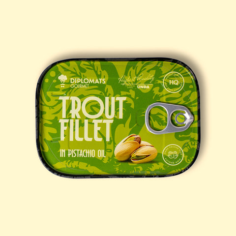 Trout fillet in pistachio oil in green packaging with black borders, featuring an image of pistachio nuts.