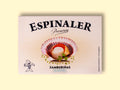 A cream-coloured rectangular box with an open variegated scallop in its shell on the front, beneath Espinaler written in black lettering. The tin is on a pale wood background.