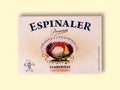 A cream-coloured rectangular box with an open scallop in its shell on the front, beneath Espinaler written in black lettering. The tin is on a pale wood background.