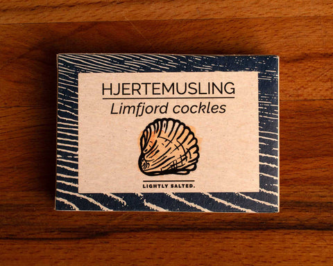 Limfjord cockles in white and blue packaging, featuring an illustration of a cockle, with text beneath reading lightly salted.