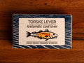 A tin of Icelandic cod liver in white and blue packaging, featuring an illustration of a cod with the text "lightly smoked" beneath.