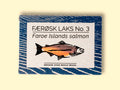 Tinned Faroe Islands Salmon with white and blue packaging, featuring an illustration of a salmon with text beneath reading smoked over beech wood.