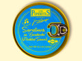 A tin of sardines in escabeche, featuring light blue packaging with golden corners and the Los Peperetes label at the top, set against a yellow backdrop