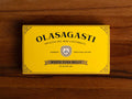 A tin of white tuna in olive oil, packaged in a yellow rectangular box featuring the brand name Olasagasti.