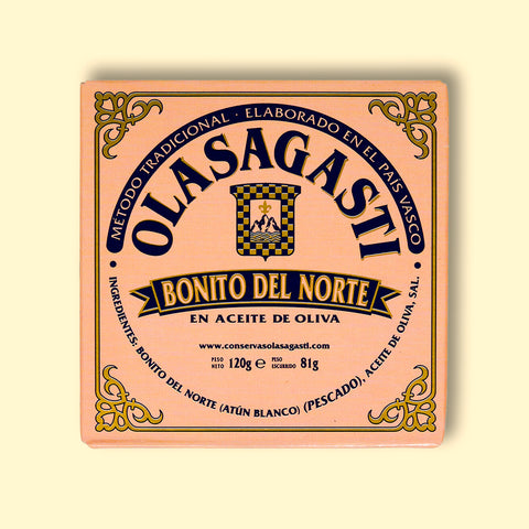 A square tin of tuna with pink packaging and Olasagasti written in blue lettering on the front, against a pale background
