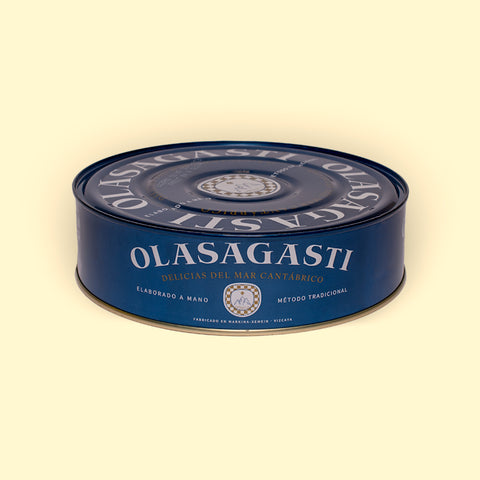 A large circular tin of tuna. The tin is blue and illustrated with big letters reading olasagasti, the brand name
