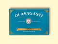 Olasagasti anchovy fillets blue packaging on a yellow surface. The design is simple with many details like a Sicilian coat of arms, a golden banner and decorative details on the corners.