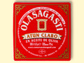 A square red box with Olasagasti written in white lettering inside an ornate gold border.