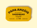 Sardines with olive oil and lemon in vivid yellow packaging, featuring Papa Anzóis displayed at the top.