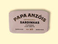 Smoked sardines in olive oil in light grey packaging, with Papa Anzóis displayed at the top.