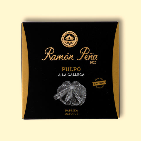 Tinned paprika octopus in black and gold packaging. Ramón Peña is written in raised gold lettering above a silver grey image of an octopus on the front of the packaging.