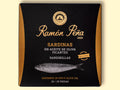 Spicy sardines in black and gold card packaging. Ramón Peña is written in gold lettering above a silver-grey image of a sardine.