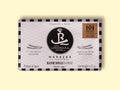 Razor clams in black and white card packaging, with a silver and black border and illustrations of razor clams either side of the Real Conservera logo.