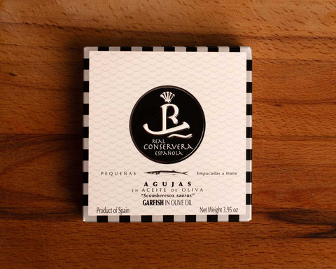 A tin of garfish in olive oil in rectangular white packaging, featuring an illustration of a garfish.