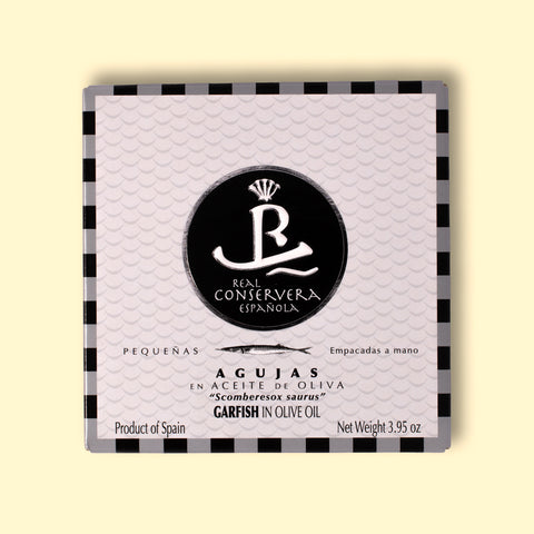 A tin of garfish in olive oil in rectangular white packaging, featuring an illustration of a garfish.