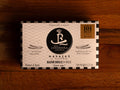 Razor clams in black and white card packaging, with a silver and black border and illustrations of razor clams either side of the Real Conservera logo.