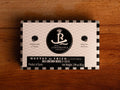 A rectangular tin of sea urchin roe in brine, with white and black packaging, displaying sea urchin illustrations next alongside the Real Conservera logo.