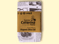 A tin of Santa Catarina tuna in black and white packaging with a gold label against a yellow wood background