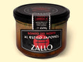 A jar of tuna fillets with a black and red label featuring Japanese iconography against a wood background.