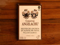 A tin of large Cantabrian anchovies in rectangular cream packaging with a brown border, against a wood backdrop.