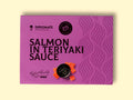 A can of salmon in purple card packaging with dark purple lettering. There is an image of diced salmon by a bowl of teriyaki sauce.