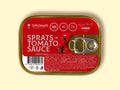 A golden-coloured rectangular tin with a silver ring-pull on the right. The tin is on a pale yellow background. The tin has a red sticker covering its surface with "sprats in tomato sauce" written in white lettering by an image of some tomatoes. The ingredients and nutrients are written at the bottom of the label in small white type.