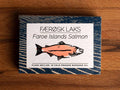 A tin with a blue border and a pink-coloured salmon on the front