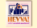 Box containing Cornish mackerel from Hevva! The box is illustrated with a fisherman calling out over the Cornish coast with cliffs and a lighthouse in the background. The box is colourful with the Hevva name written in golden, embossed lettering