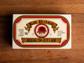 A tin of cod in white packaging with a red border, and an image of a red rose on the front below La Rose written in red lettering on a gold banner