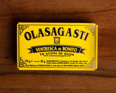 A tin of tuna belly in a rectangular yellow box with blue lettering and a gold border. 