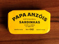 Sardines with olive oil and lemon in vivid yellow packaging, featuring Papa Anzóis displayed at the top.