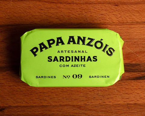 A tin of sardines in olive oil in lime green packaging, featuring the Papa Anzois brand name on top.