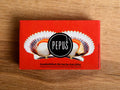 A tin of scallops in rectangular red card packaging. There is an image of two scallops in their shells with the Pepus circular logo overlaid.