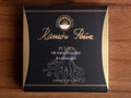 Tinned paprika octopus in black and gold packaging. Ramón Peña is written in raised gold lettering above a silver grey image of an octopus on the front of the packaging.