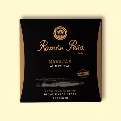 Razor clams in a square black and gold box with Ramón Peña written in raised gold lettering above a silver grey image of a razor shell.