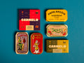 Collection of premium tinned fish in colourful wrappers. One of them is a sardine with lemon, another is the stew sardines from Nuri and also de smoked oysters from Carmelo