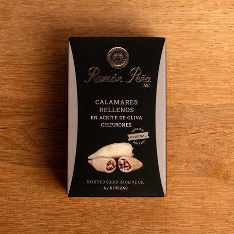 A tin of Ramon Pena stuffed in squid in olive oil, in black card packaging with silver lettering and an illustration of a squid with stuffed tentacles.