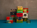Stacks of colorful tinned fish from Spain and Portugal on a blue and gray background