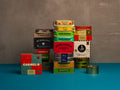 Stacks of colorful tinned fish from Spain and Portugal on a blue and gray background