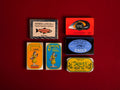A selection of colourfully-packaged tinned
sardines, tuna, mackerel, salmon and mussels against a red background.