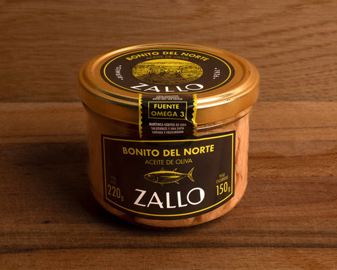 A jar of tuna fillets in olive oil with black and yellow labelling