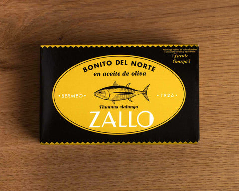 A tin of tuna in black and yellow card packaging, with Zallo written below an illustration of a tuna fish.