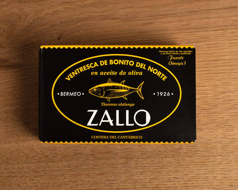 A rectangular box with light orange lettering and an image of a tuna, with Zallo written in white beneath it