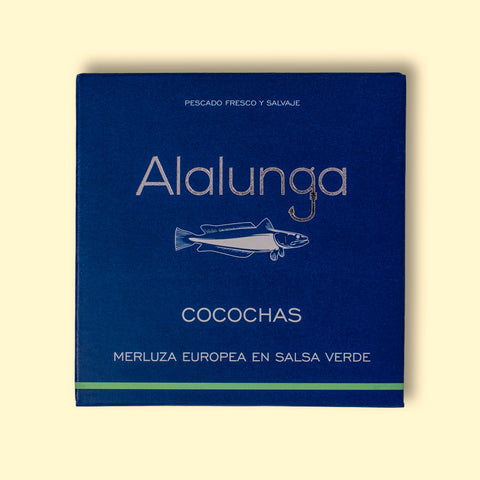 A tin of hake cheeks in green sauce, in square, blue, card packaging with Alalunga written in silver lettering above an illustration of a hake.