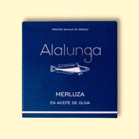 Hake in olive oil in square, blue card packaging with Alalunga written in silver lettering above an illustration of a hake.
