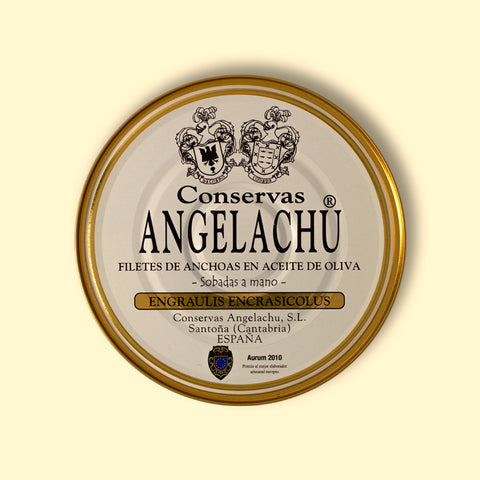A tin of 32 cantabrian anchovy fillets in a circular white container with golden borders, set against a yellow backdrop.